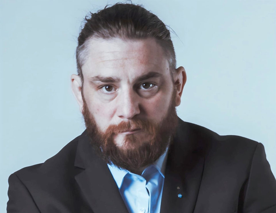 Ross Lavery - headshot, black suit